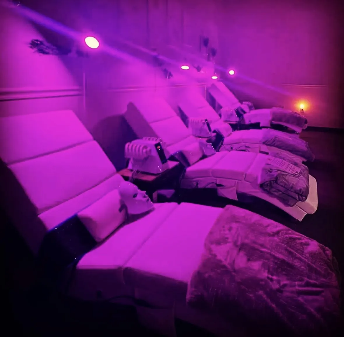 Reclining chairs and equipment in the pink-lit Lounge
