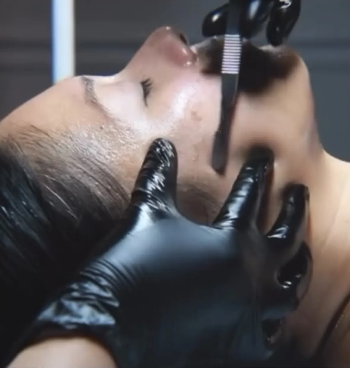 Gloved hands providing facial care to a guest at The Lipo Lounge & Spa