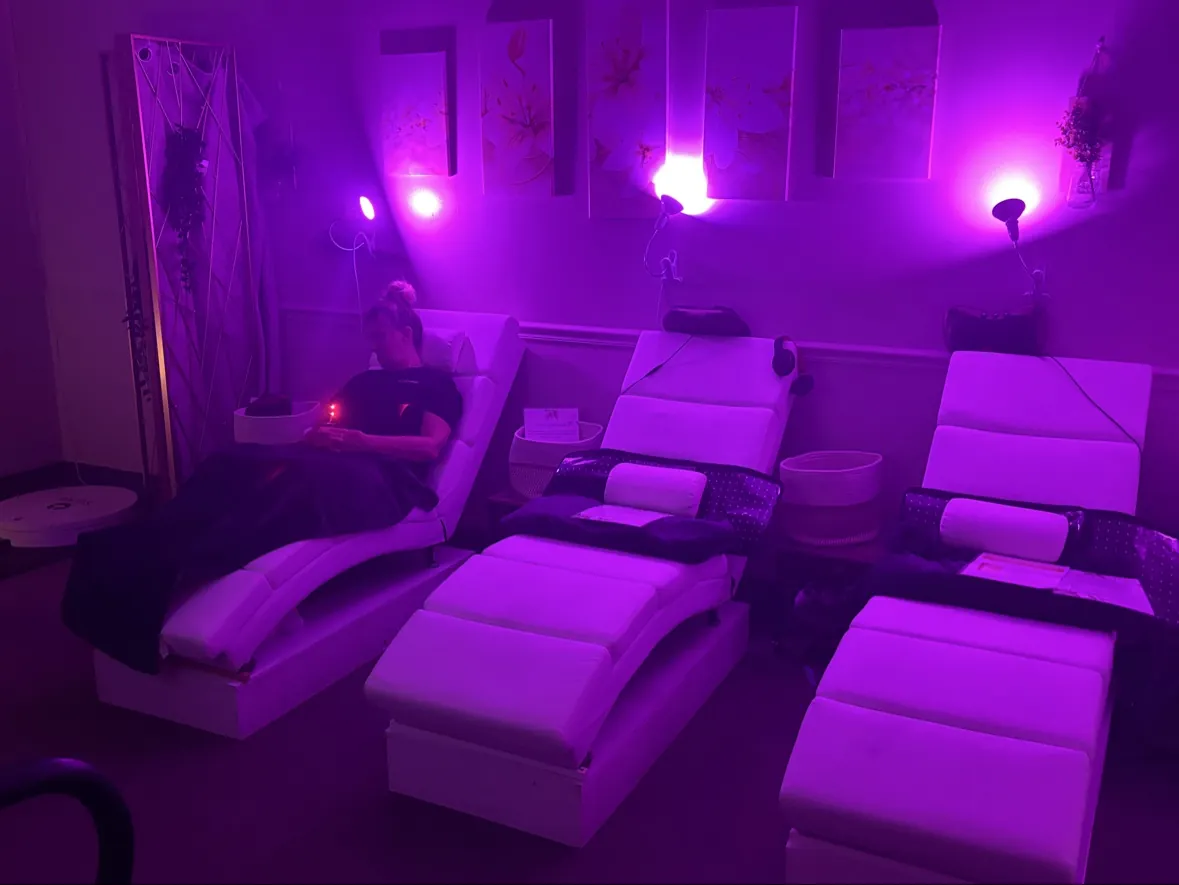 Reclining chairs and softer purple-pink lighting inside The Lipo Lounge
